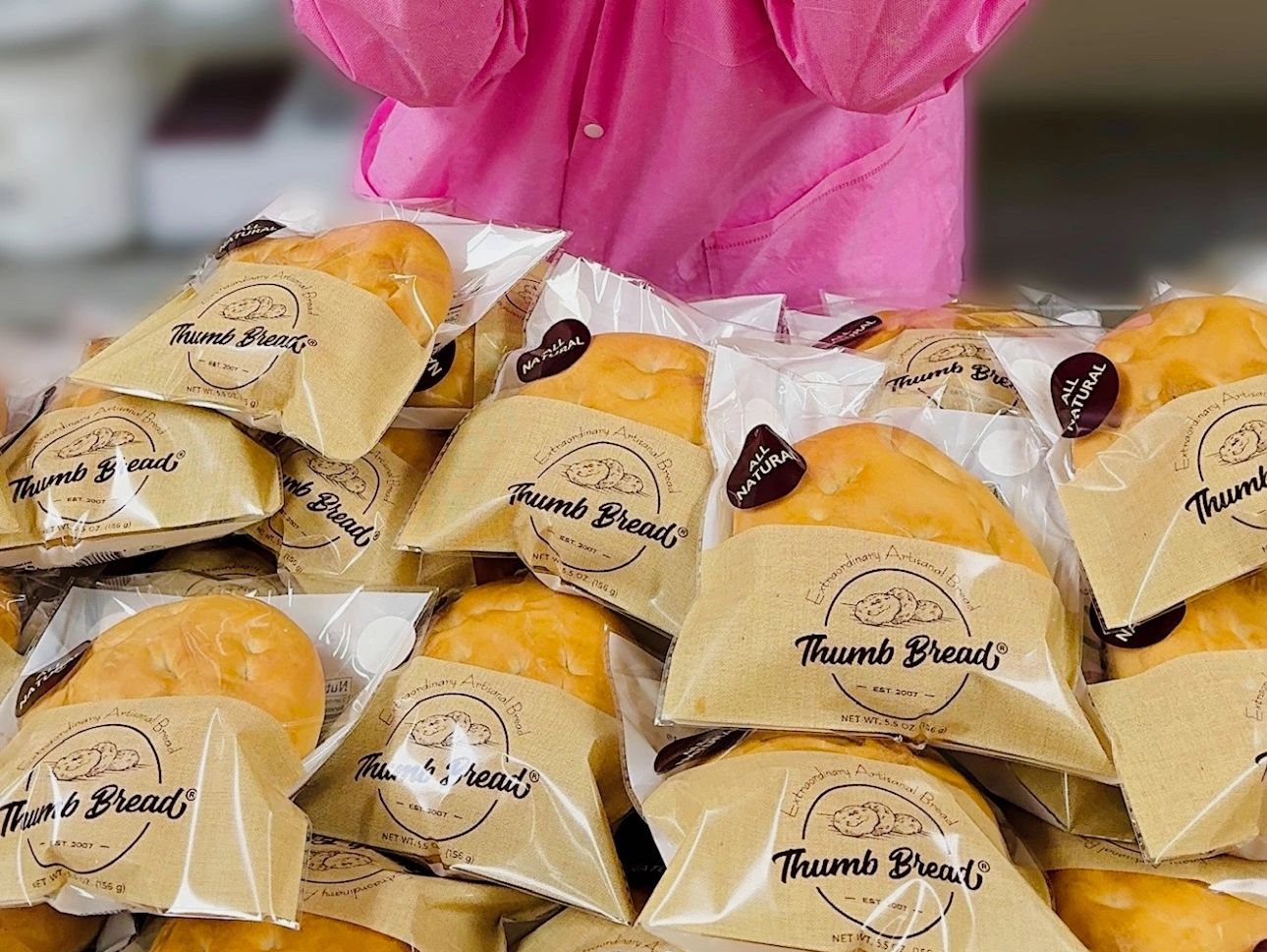 Bags of individually wrapped Thumb Breads stacked together