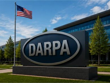Signboard of DARPA headquarters with an American flag flying beside it.