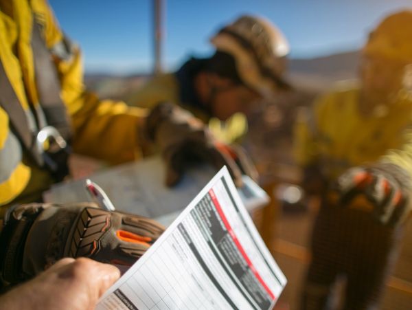 Construction engineers writing in a form