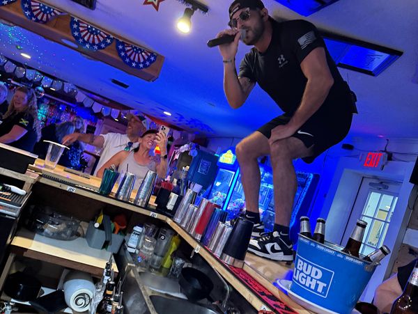 Singer standing on bar