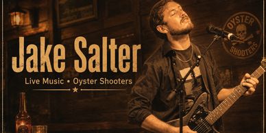 Jake Salter performing live with guitar at Oyster Shooters.