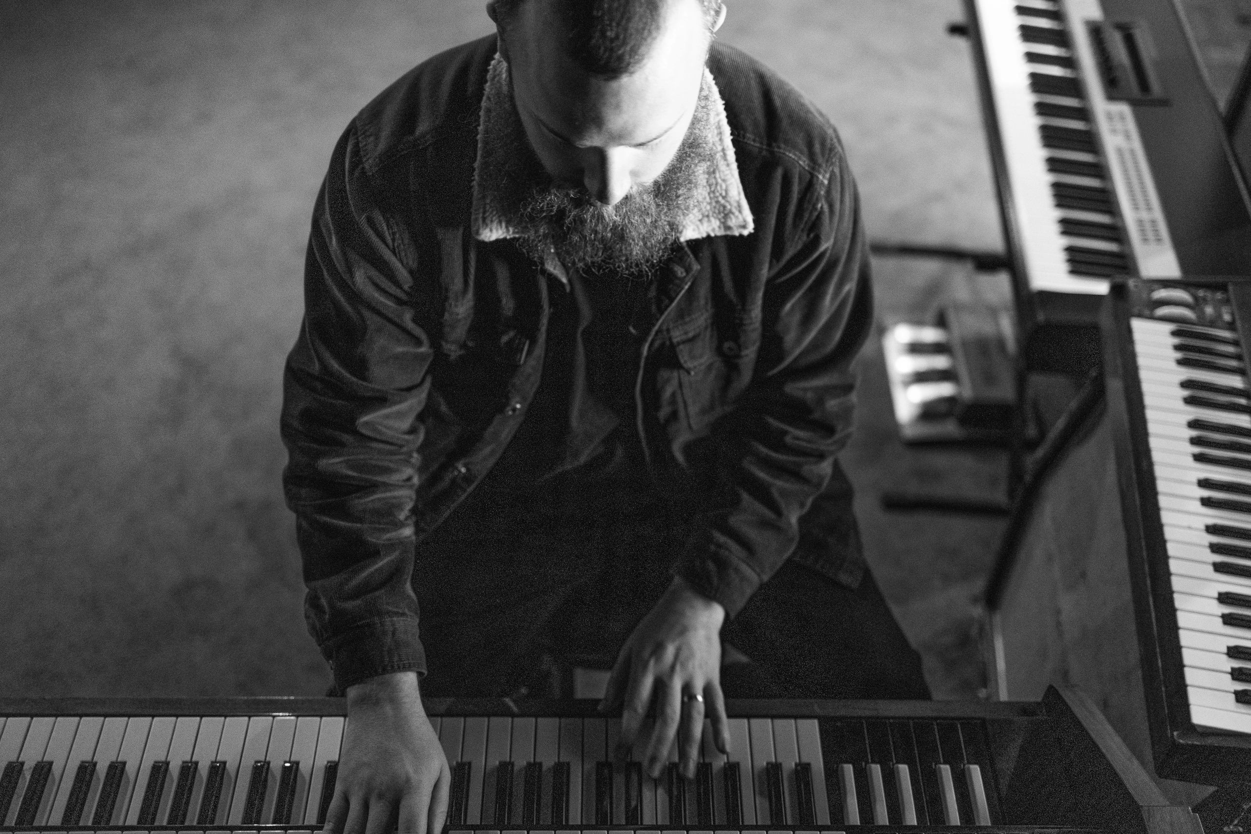 Callum Edwards songwriting and producing on a range of keys. Overhead view.