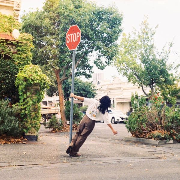 Front cover of Danna. She is swing around a stop sign in Melbourne's inner north
