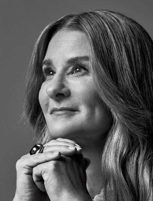 Woman in thoughtful pose with hands clasped.