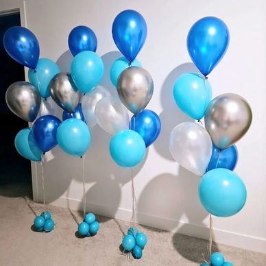Clusters of blue and silver balloons arranged in groups.