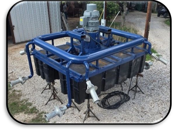 Industrial mechanical device with blue pipes and motor.