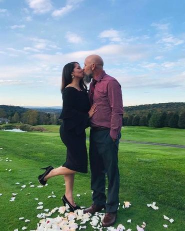 A couple kissing on a valley.