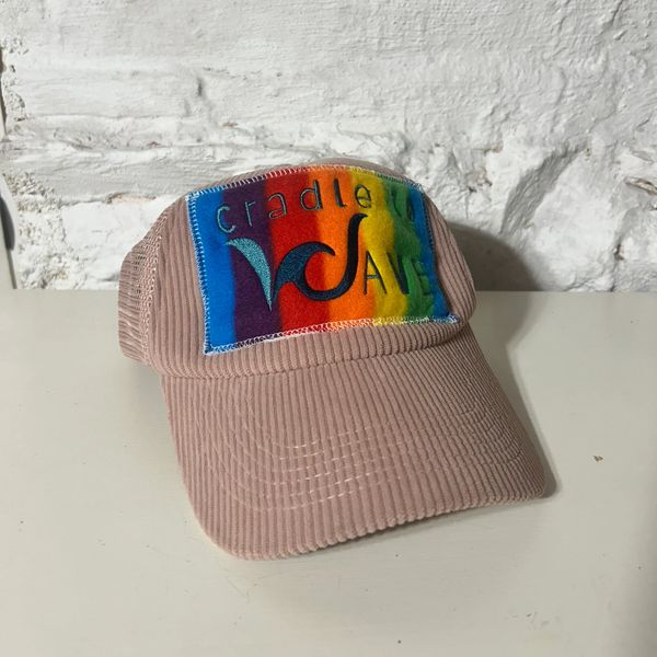 Beige corduroy cap with rainbow patch.
