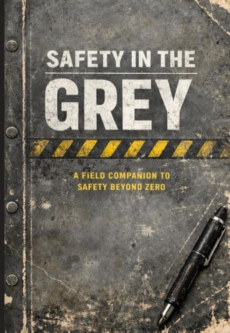 Cover of a rugged safety guide titled 'Safety in the Grey' with a pen on a worn surface.