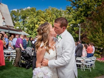 A bride and groom kiss at the wedding venue near the Ovid Inn Event Center