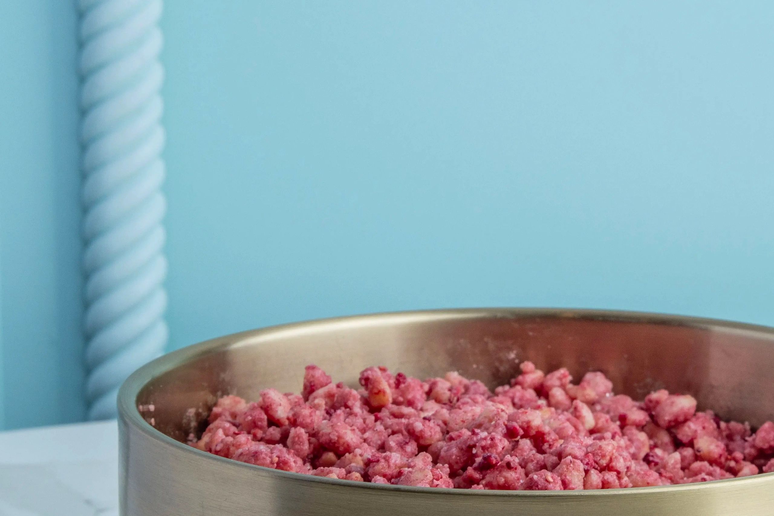Close-up of a bowl filled with minced pink meat.
