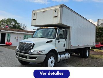A white box truck parked outside on a sunny day.