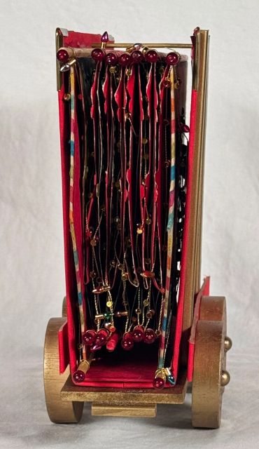 Side view of a jewelry organizer on wheels.