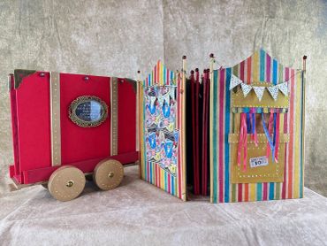 Colorful toy circus wagon with accordion sides.