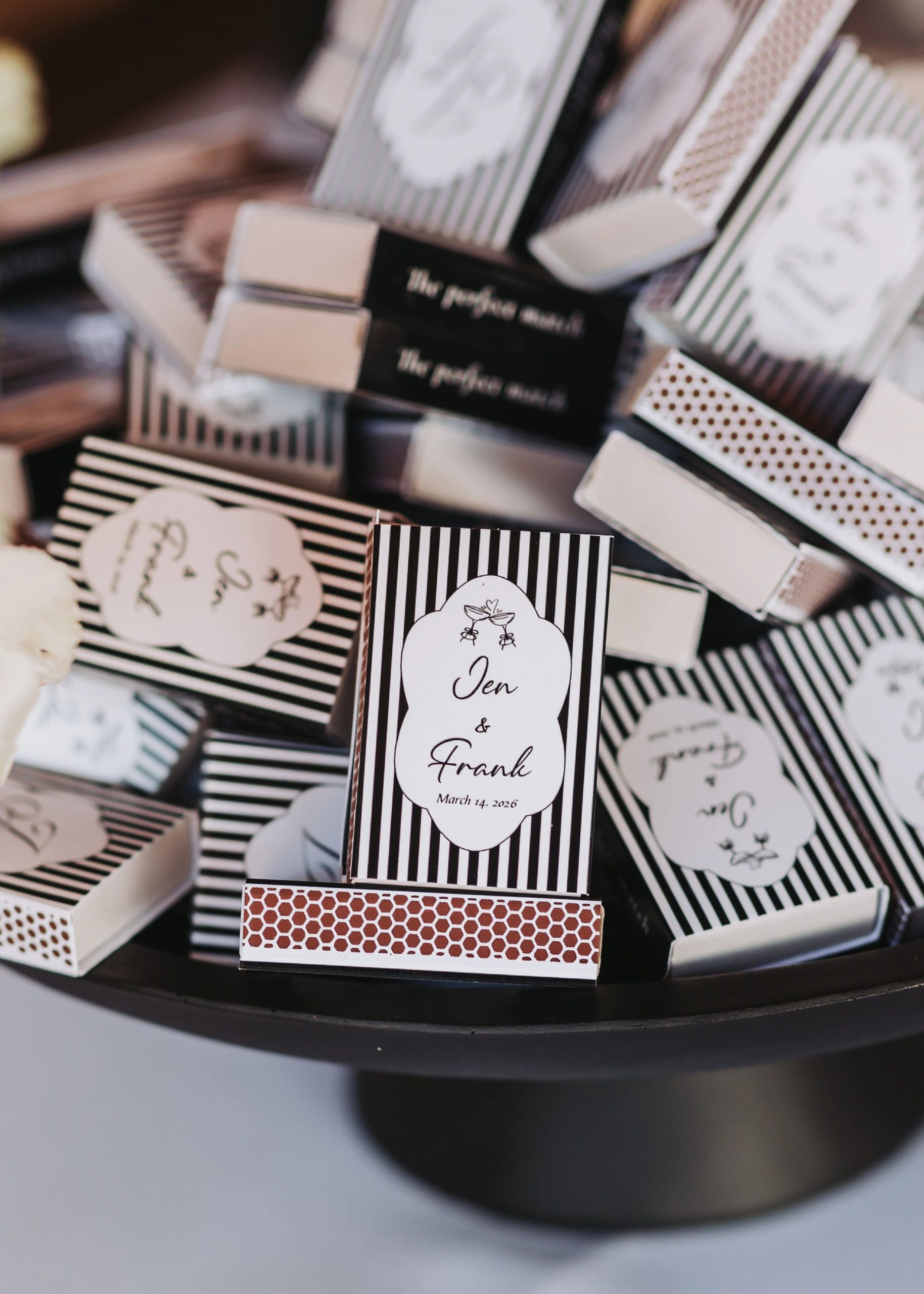 Wedding favor boxes labeled Jen &amp; Frank, March 14, 2026, with elegant striped designs.