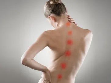Woman with highlighted spine pain points on her back.