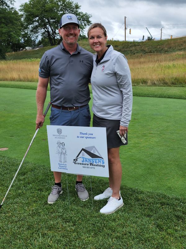 Owner, Corey and Tammy Jansen at the annual Brookfield Academy golf outing where they sponsor a hole