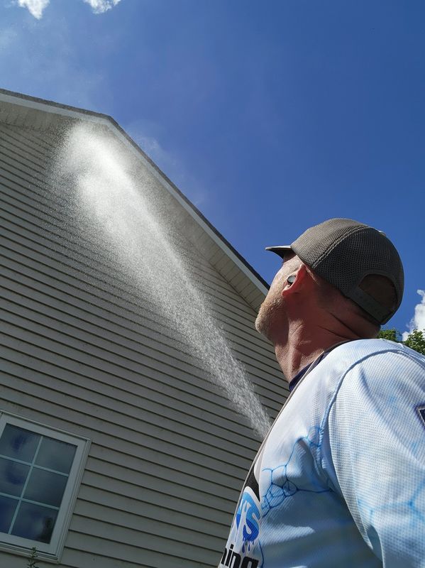 Soft-washing a house with vinyl siding