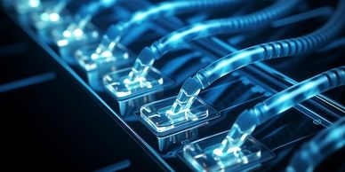 Close-up of glowing blue Ethernet cables plugged into a network switch.