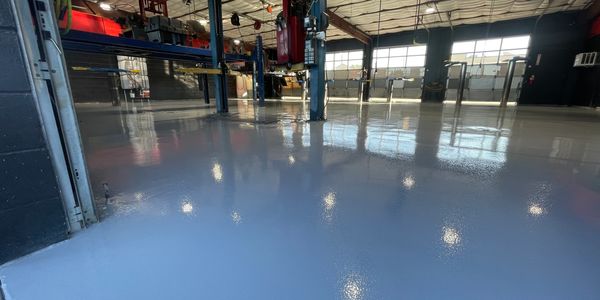 Grey Epoxy Solid Color Installed In A Commercial Mechanic Garage Floor.