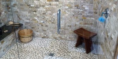 Custom shower stall featuring travertine wall and floor tile.  Formed in soapstone. Gulfport, FL.