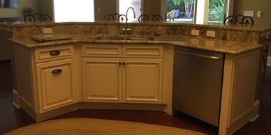 Custom made kitchen island with elegant granite countertops by Tampa Remodeling Contractor. 
