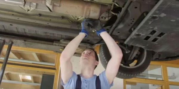 Mechanic working under a car