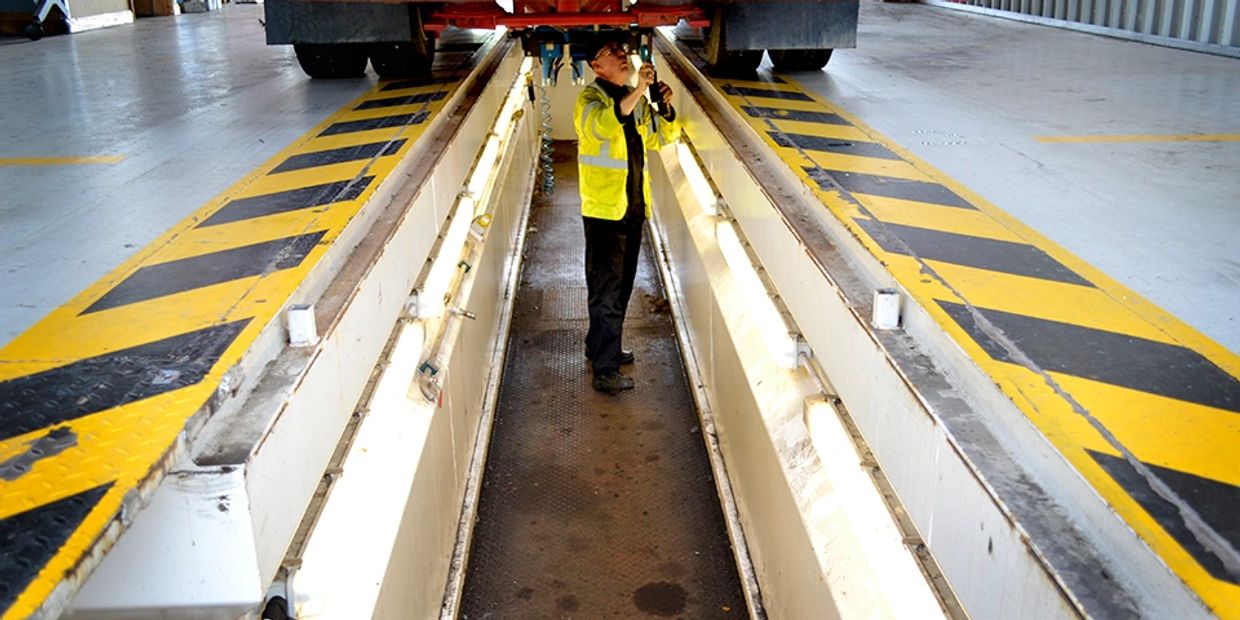 Mechanic performing HGV MOT inspection in our indoor pit lane