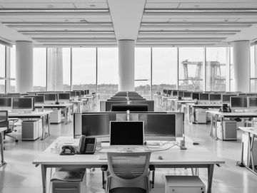 Office space with multiple workstations consisting of dual monitors, laptop docking station and acce