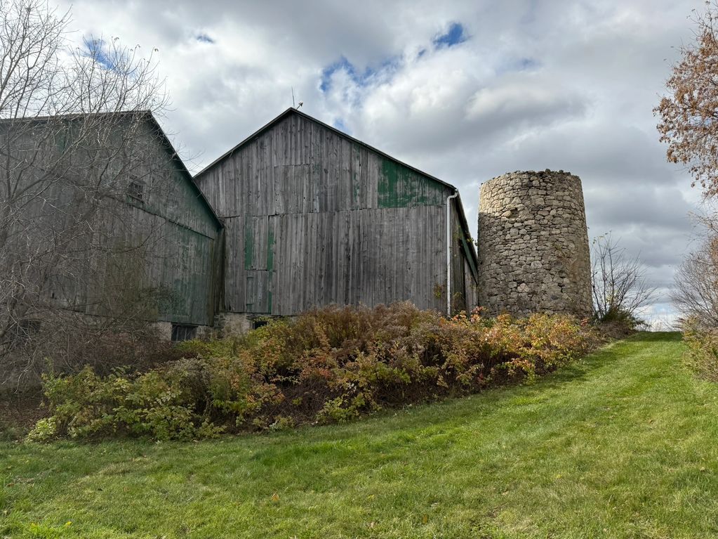 Once the proud centerpiece of a working farm, this century-old barn sheltered cattle beneath its soa
