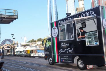 A Slice of Italy Sydney mobile pizza catering truck serving fresh Italian pizzas at Sydney Harbour.