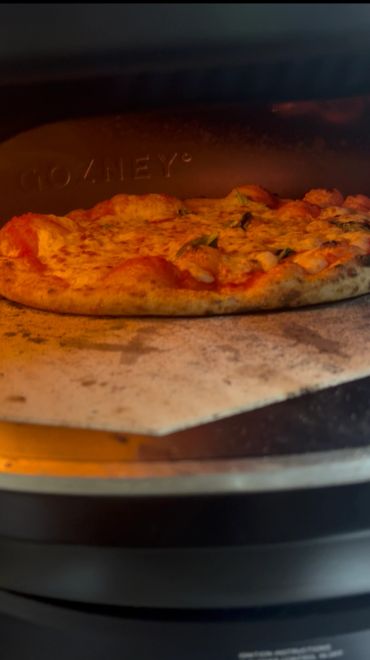 Fresh Neapolitan pizza baking in a Gozney gas oven during mobile pizza catering in Sydney