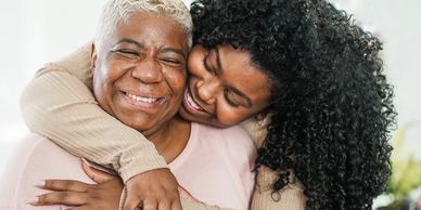 A happy Senior lady enjoying a huge hug from her daughter