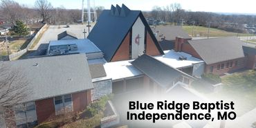 Aerial view of Blue Ridge Baptist Church in Independence, MO with a water tower in the background.