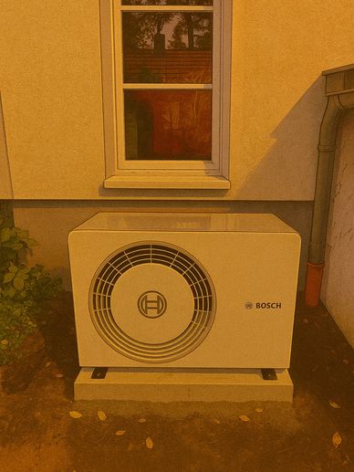 Bosch outdoor air conditioning unit installed beside a house window.