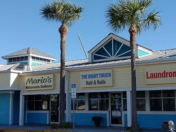 Strip mall with Mario's restaurant, a hair and nails salon, and a laundromat.