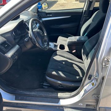 Clean and spacious car interior with black upholstery and silver accents.
