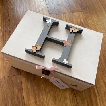 White wooden Memory Box with large, grey, wooden, letter initial, baby feet and butterfly embellishm