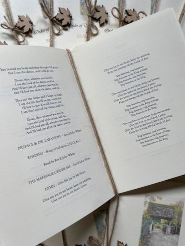 Set of wedding 'Order of Service' booklets, with wooden leaf and rustic twine embellishments.