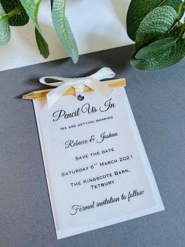 White, Save the Date Invitation with pencil attached by white ribbon