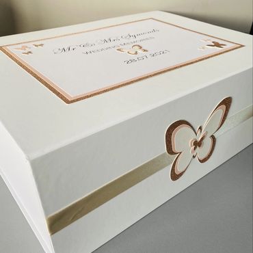 White Wedding Keepsake Box, with white & gold label and white, pink & gold butterfly embellishments.