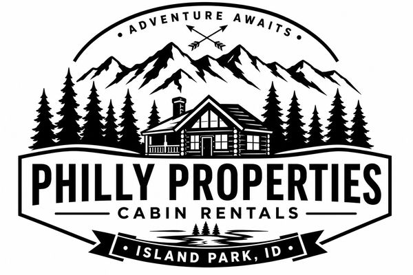 Logo for Philly Properties cabin rentals in Island Park, ID, featuring mountains and a cabin.