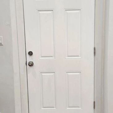 Cheap Locksmith Service installing a brand new door 
