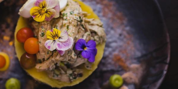 Gourmet dish with edible flowers and vegetables.