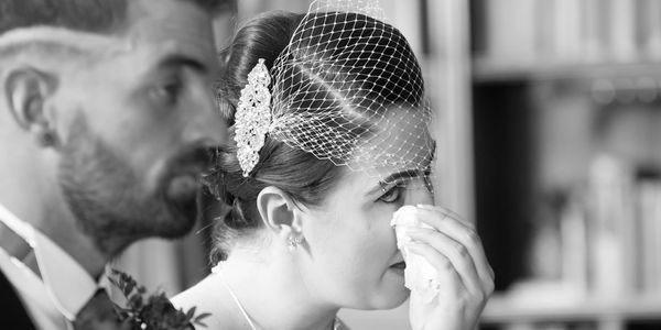 the bride sheds tears during the wedding ceremony at Eynsham Hall wedding venue in Oxfordshire