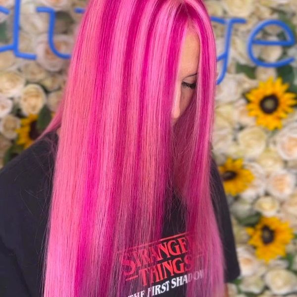 Woman with vibrant pink hair and a Stranger Things shirt.