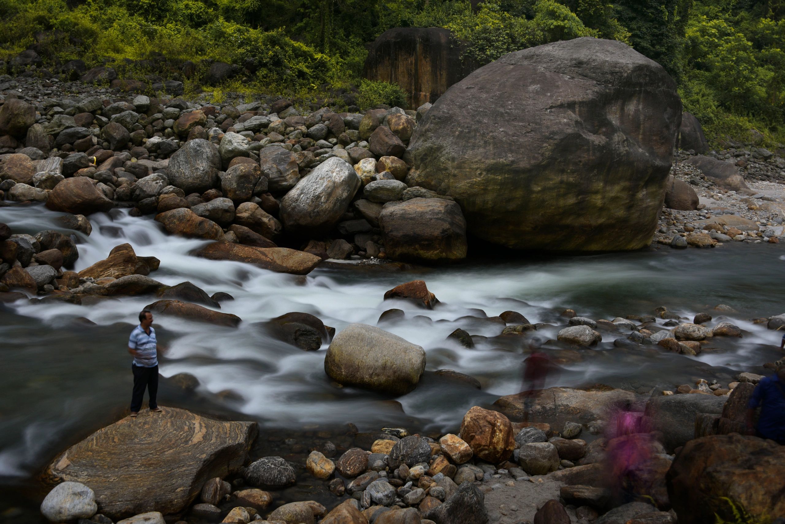 Flow of river water captured in long exposure blurry motion photography.
