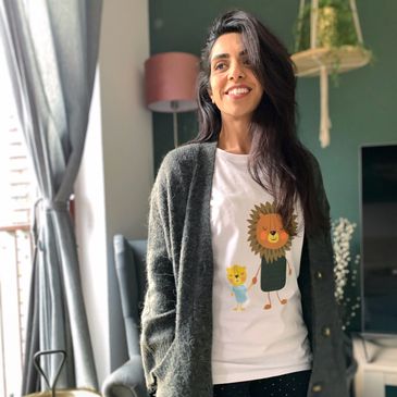 Amber the illustrator wearing a t-shirt wearing with Baba Lion and Little Lion