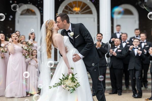 Newly married couple kissing in front of a church on Long Island