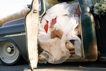 cute photo of a bride kissing a groom in a pickup truck